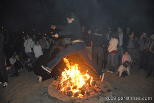 Woman jumping ovrt fire at the Chahar Shanbeh Souri Festival - LA (March 18, 2008) - by QH
