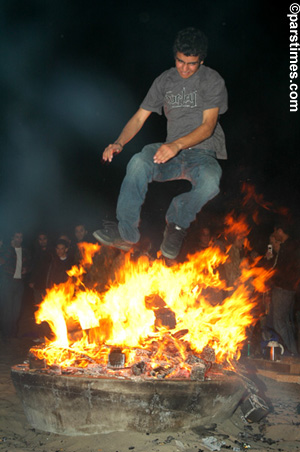 Man jumping over the bonfire (March 14, 2006) - by QH
