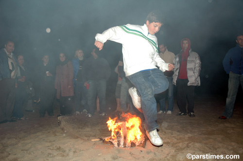 Boy jumping over the bonfire (March 14, 2006) - by QH
