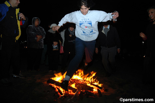 Man jumping over the bonfire (March 14, 2006) - by QH