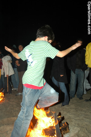Women jumping over the bonfire (March 14, 2006) - by QH
