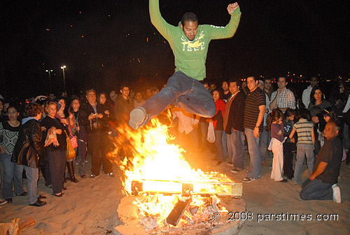 man jumping over fire