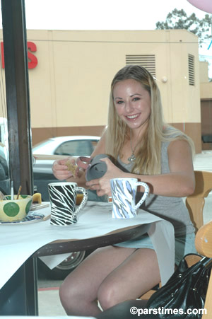 Woman painting cups, Studio City - by QH