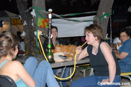 Woman smoking a waterpipe - by QH - Woodland Hills (October 22, 2006)