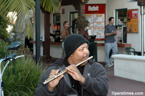 Musician playing the flute on State St. (February 28, 2006) - by QH