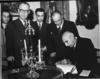 Prime Minister Mohammad Mossadegh of Iran signing the guest book at Mount Vernon.