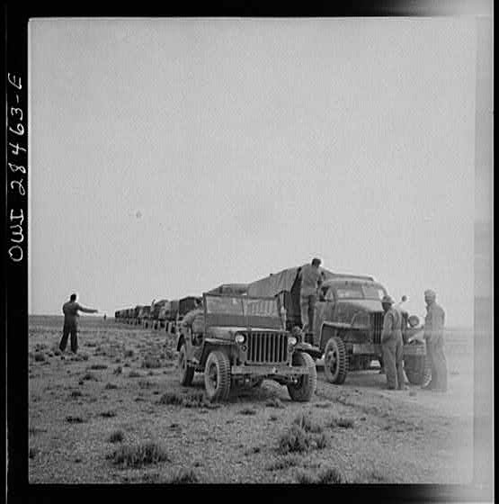 Somewhere in the Persian corridor. A United States Army truck convoy carrying supplies for Russia making a rest stop in the desert.