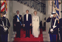 The Shah of Iran, President Nixon, and Mrs. Nixon in formal attire for a state dinner in the White House, 10/21/1969 - ARC Identifier: 194302.