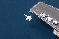 An F/A-18C over USS George Washington - Courtesy of US Navy