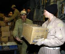 Bam Earthquake Relief: Senior Airman Lindsey Whicker hands a box of water to an Iranian soldier here Dec. 28 as part of humanitarian relief efforts - US Air Force