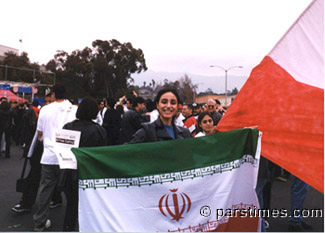 Iranain woman holding the official flag of Iran - by QH